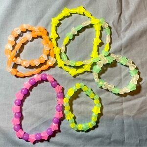 A bundle of assorted bead bracelets and anklets in different colors for kids.